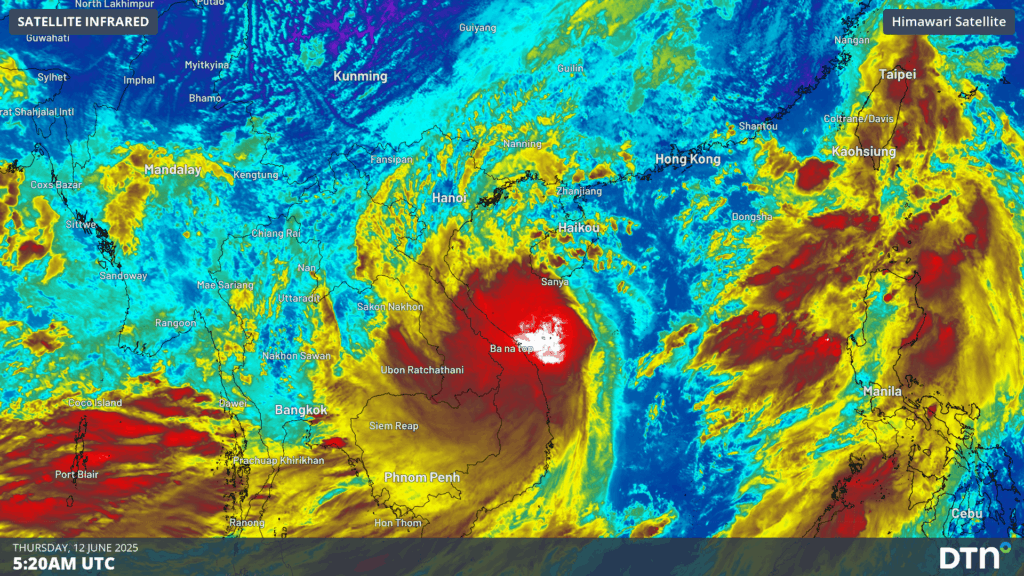An infrared satellite image depicts a powerful tropical cyclone with a well-defined eye near Vietnam, affecting southern China and nearby regions, with extensive cloud cover and intense storm activity shown in red and white.